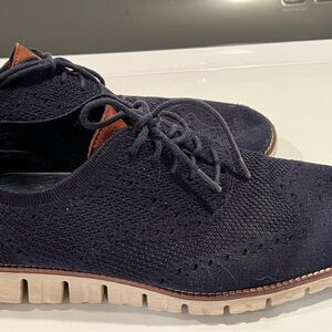 Navy blue shoe with brown accents and white sole